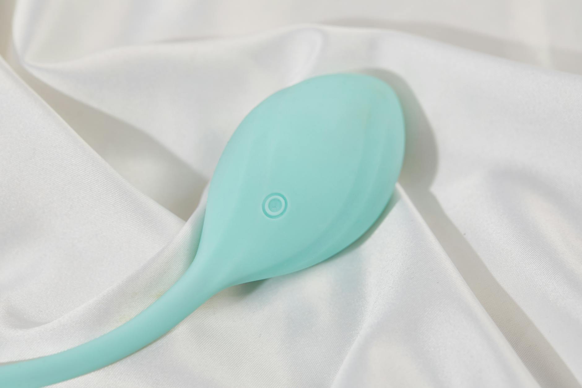 Vibrador de limón sobre tela de seda blanca suave, representando la estimulación clitoriana directa